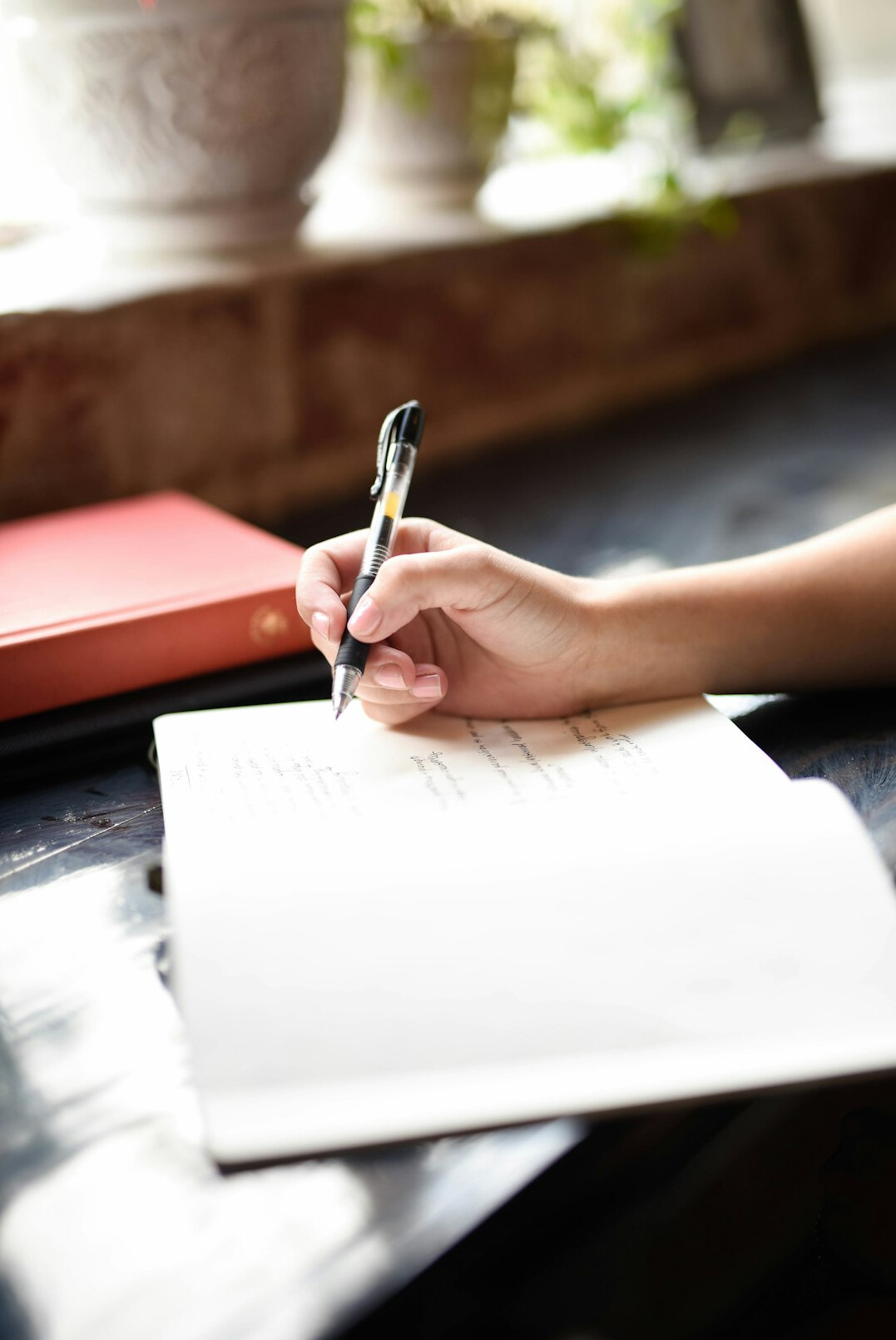 person writing in journal