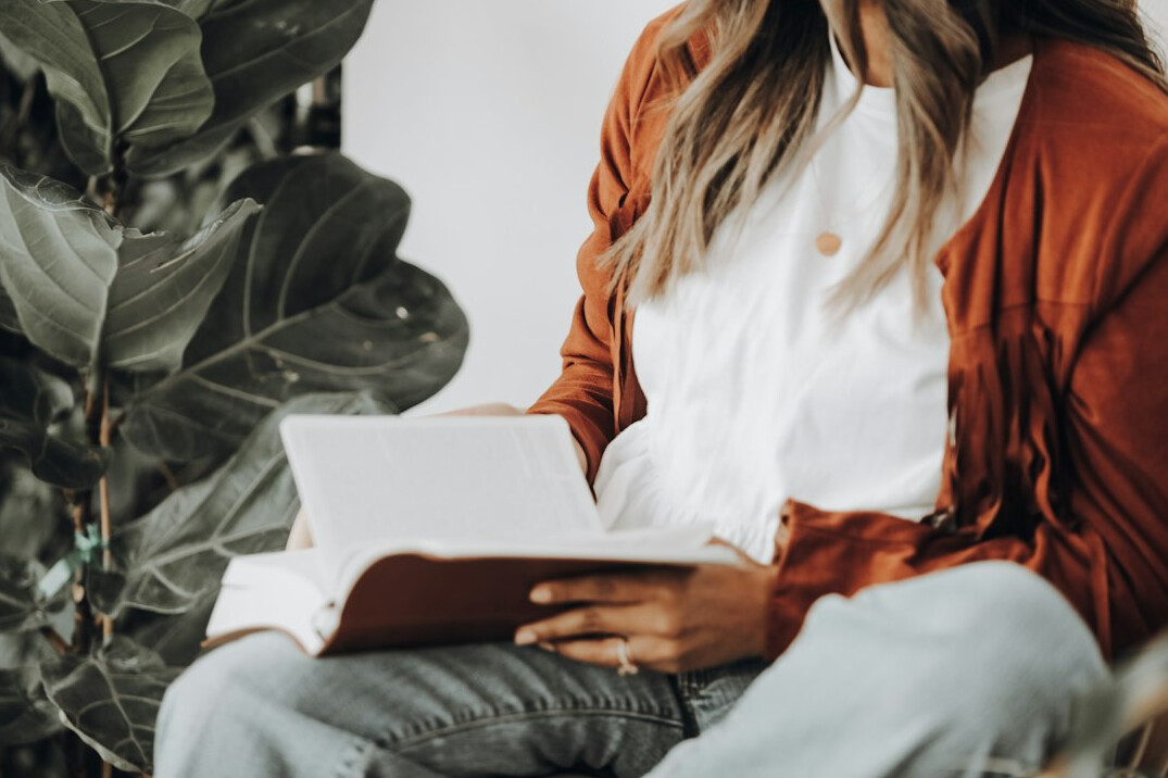 woman reflecting on journal
